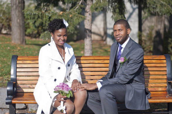 Bride and Groom sitting on a bench in Confederation Park after Ottawa City Hall Wedding