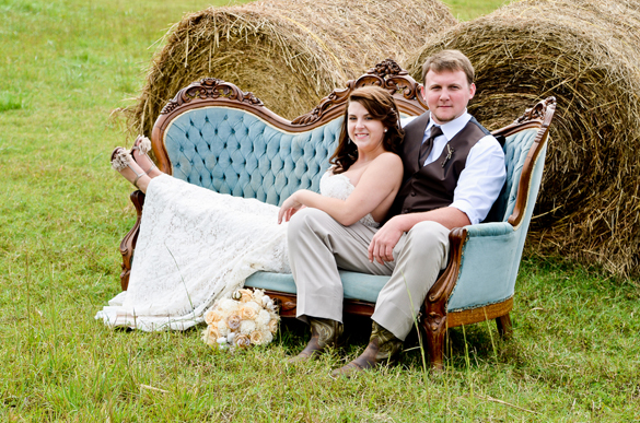bride and groom on vintage couch
