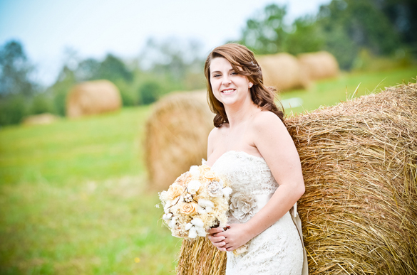 bride leaning against haystack in southern vintage wedding