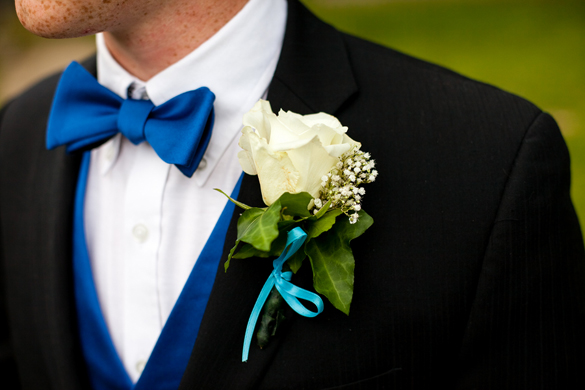groom's blue bow tie and white rose boutonniere