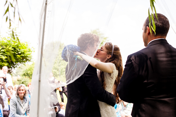pretty shot of couple kissing after pronounced husband and wife