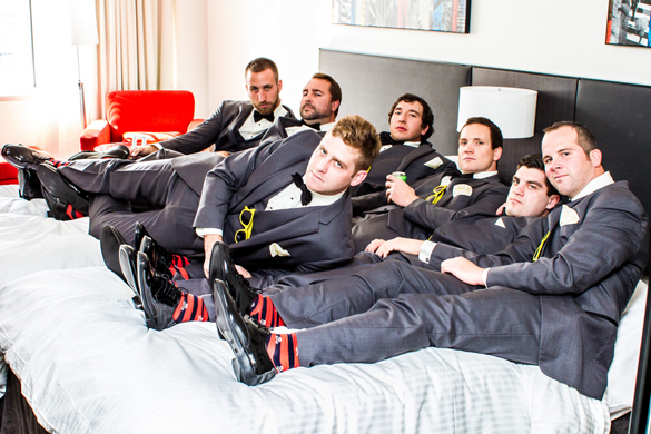 groomsmen in gray with red and black striped socks