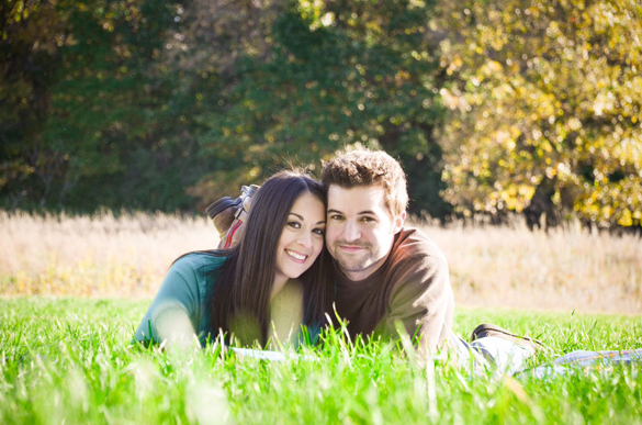 cute rustic photo of couple laying in the grass