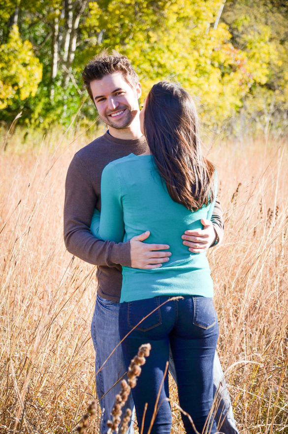 rustic engagement photo of couple in field