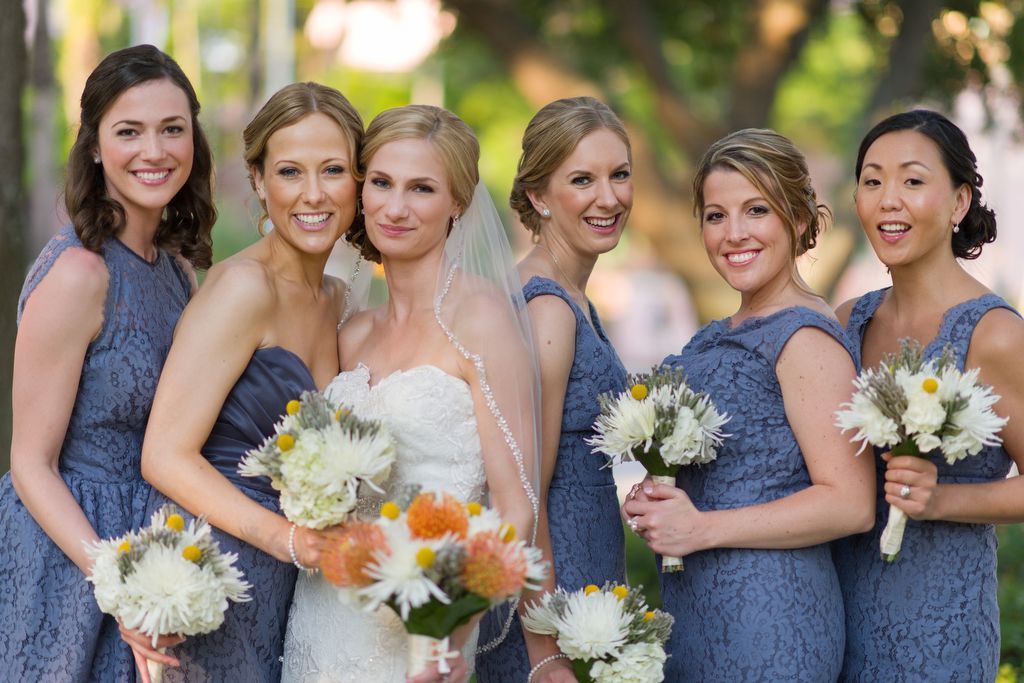 Bride with bridesmaids in mix-match blue dresses 