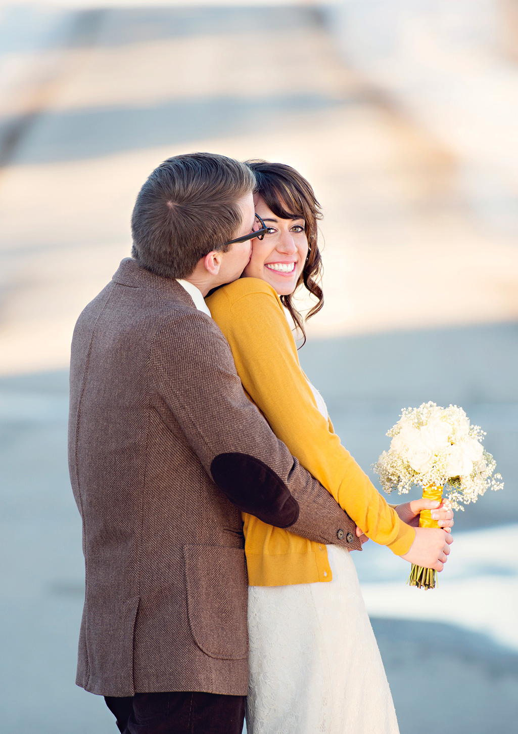 adorable bride in mustard-yellow cardigan and groom in tweed jacket