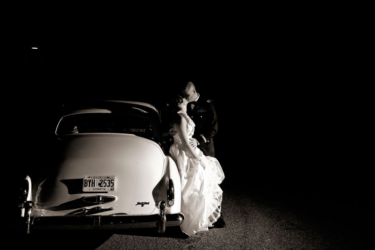 Bride and Groom next to classic car