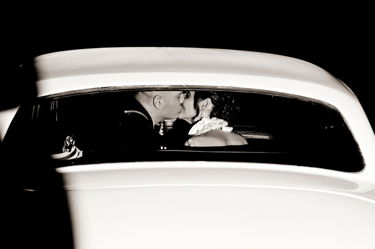 Bride and Groom next to classic car