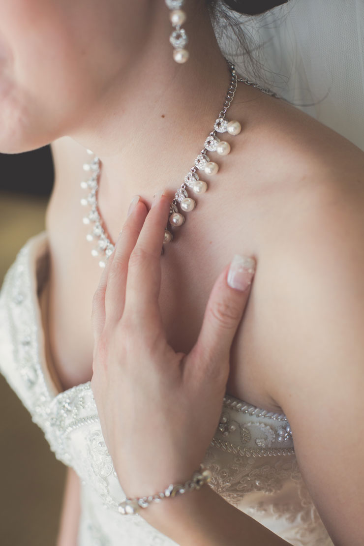 Bride wearing pearls and pearl-embellished gown