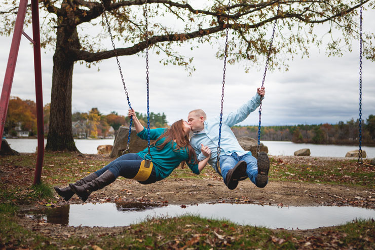 Couple swinging in outdoor fall engagement photos by Hilary Colleen Photography