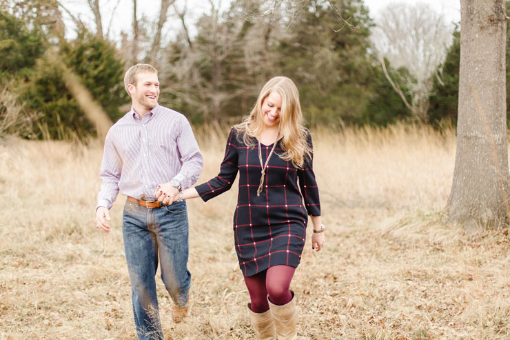 Rustic engagement photo of couple walking in Manassas Battlefield National Park (photos by Hay Alexandra Photography).