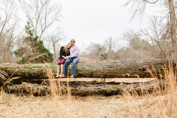Sitting on a log in Manassas Battlefield National Park engagement (photos by Hay Alexandra Photography).