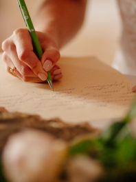 a close-up of a bride writing her wedding vows