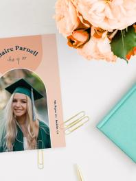 Graduation Announcement with pretty flowers on desk