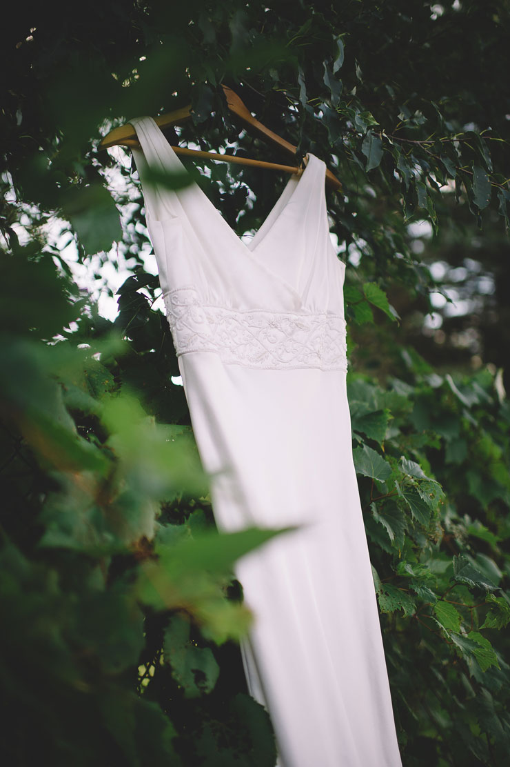 Ivory wedding dresses hanging in the trees