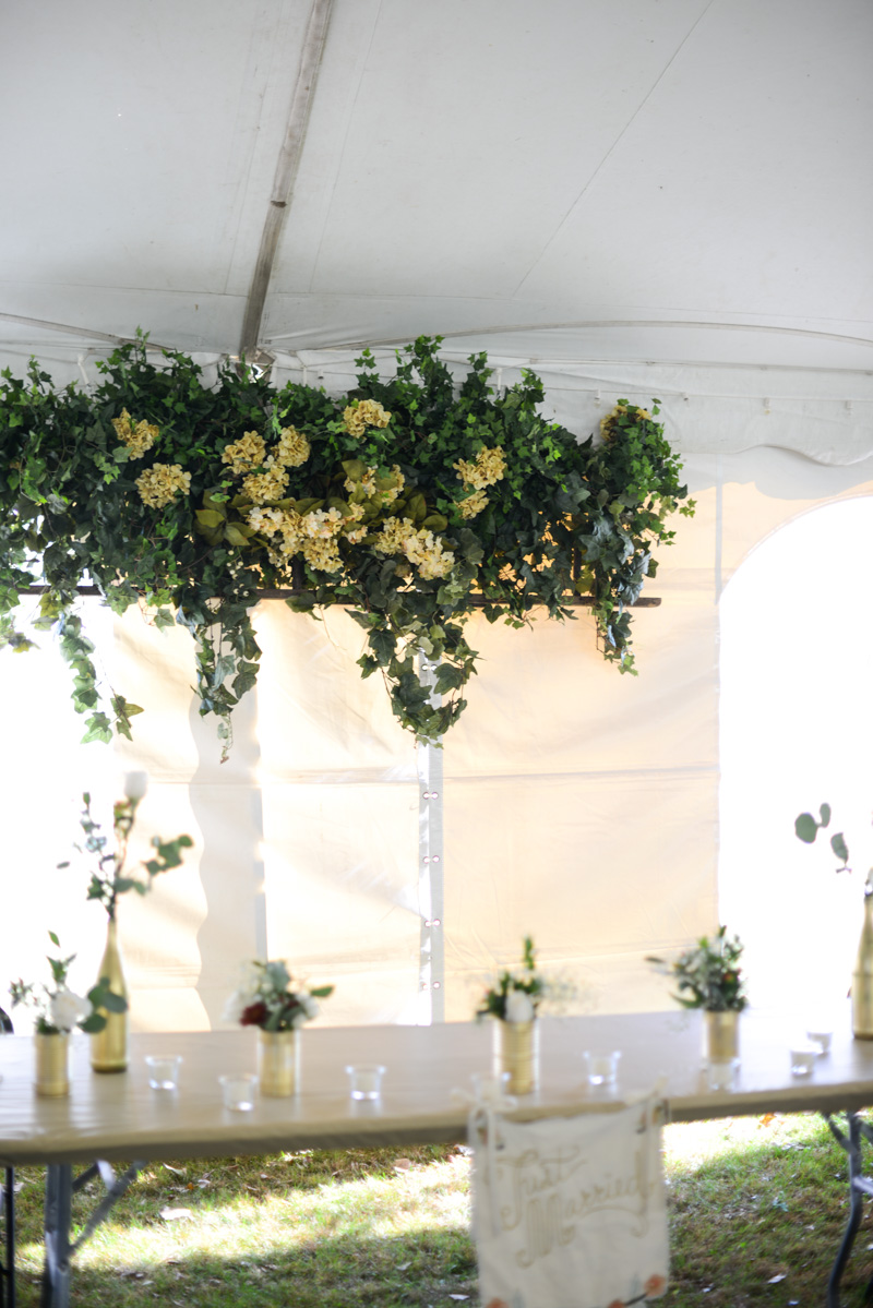 DIY floral overhang at tent wedding reception