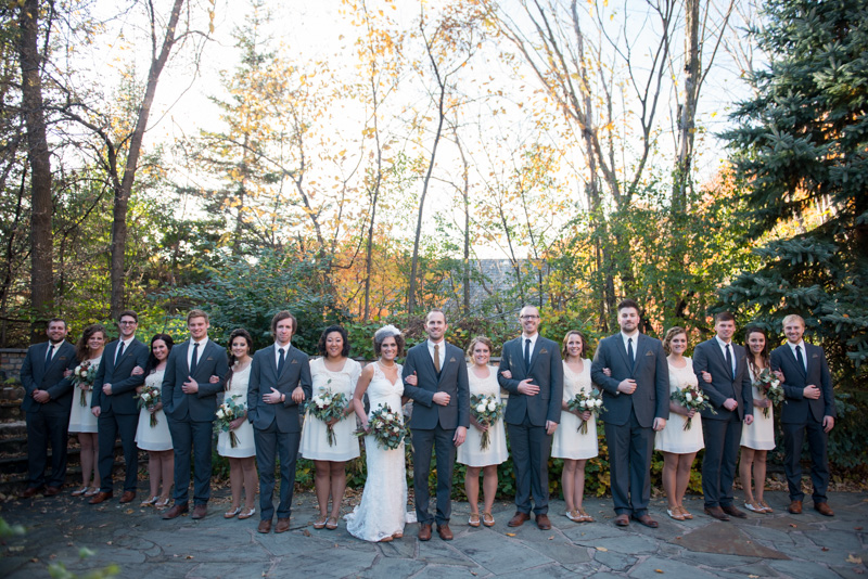 Groomsmen in gray suits and bridesmaids in ivory short dresses