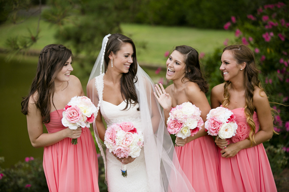Bridesmaids in coral dresses