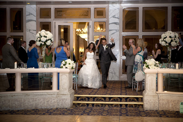 bride and groom entering hotel wedding reception