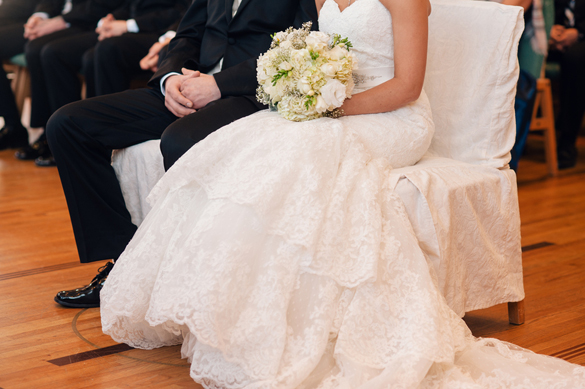 Bride and Groom sitting in chairs during intimate winter wedding.