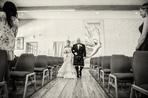 Bride being walked down the aisle by father. Intimate winter wedding.
