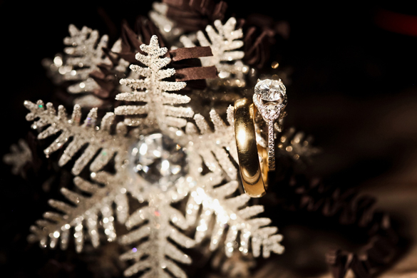 wedding rings hanging from a snowflake 