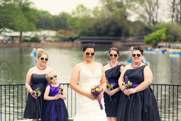 Bridesmaids in black dresses and wearing yellow sunglasses