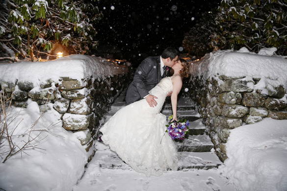 bride and groom in dip kiss at winter wedding