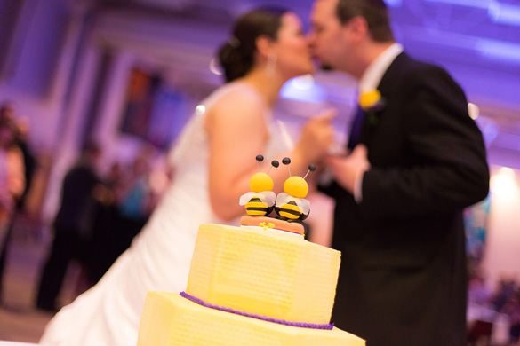 bee cake topper on yellow wedding cake 