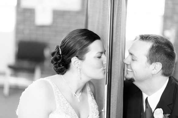 bride and groom kissing: first look wedding photo