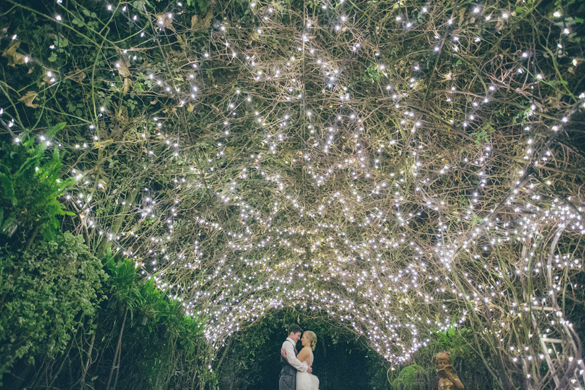 bride and groom under canopy of lights