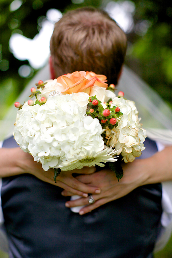 white hydrangeas and coral roses wedding bouquet