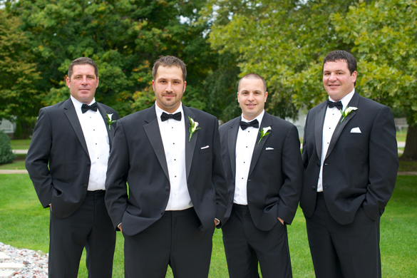 groomsmen in black tuxes and bow ties