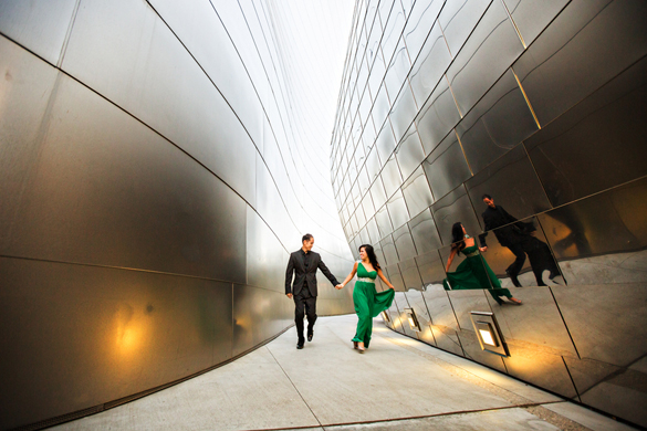 engagement photo of couple running through Walt Disney Concert Hall