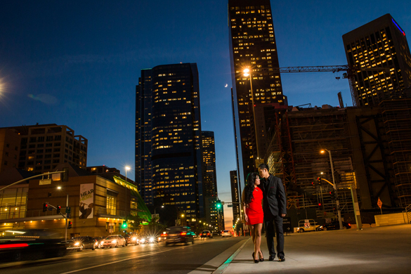 nighttime engagement photo of couple with L. A. city skyline