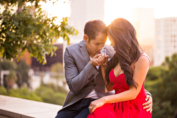 romantic engagement photo of groom kissing bride's hand