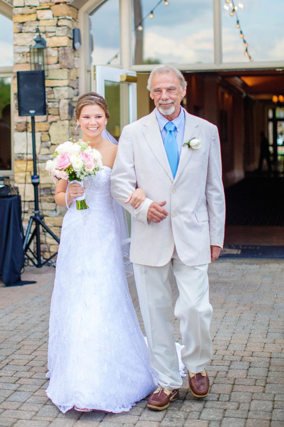 Bride walking down the aisle with father at military country club wedding.