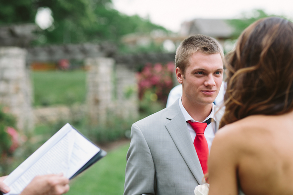 Groom looking at bride in outdoor wedding ceremony