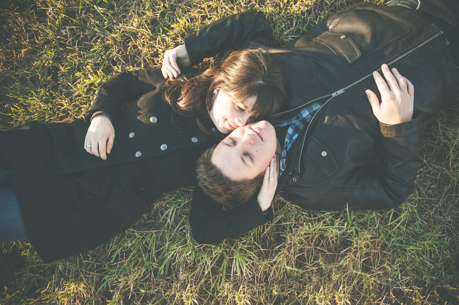 Rustic engagement sesh and couple lying down in the grass