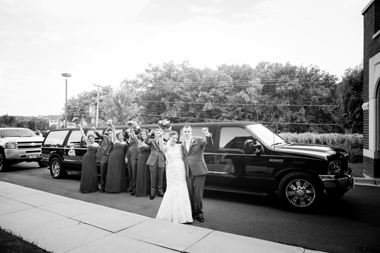 wedding party in front of limo